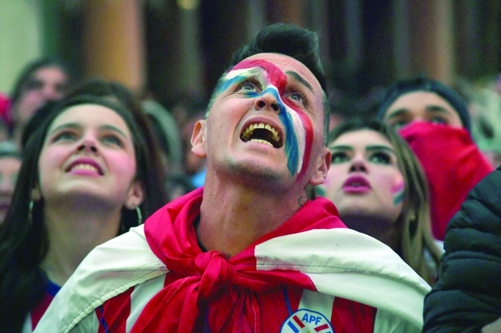 Paraguay supporters react. — AFP