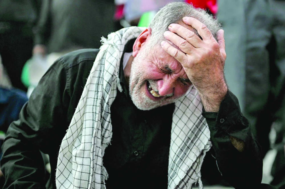 A man mourns Iran's slain supreme leader Ayatollah Ali Khamenei during the funeral ceremonies at the Grand Mosalla in Tehran. - AFP