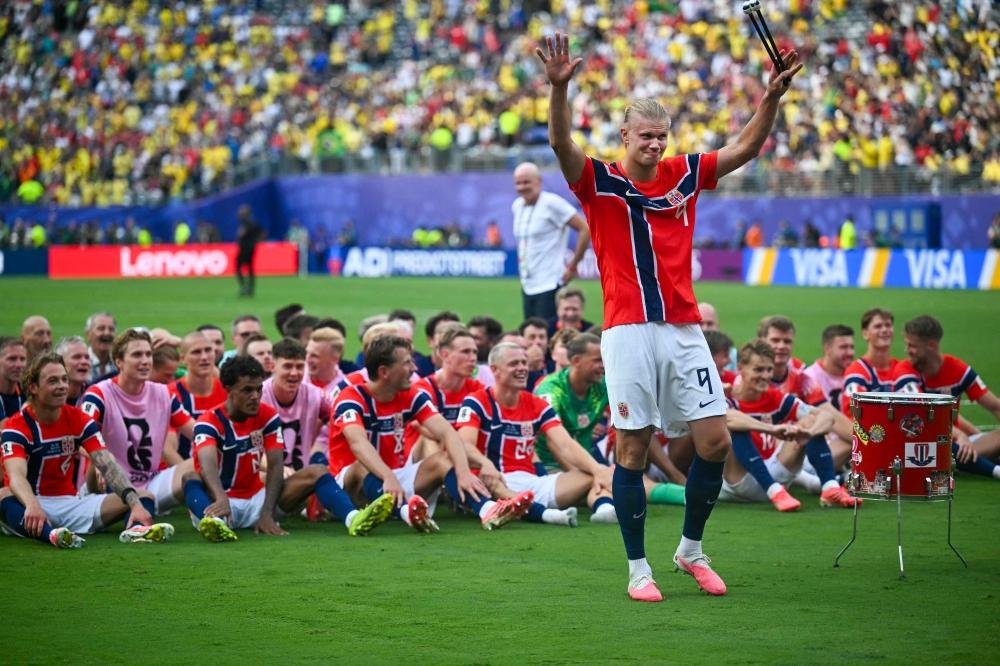 Norway's #09 Erling Braut Haaland plays the drum. — AFP