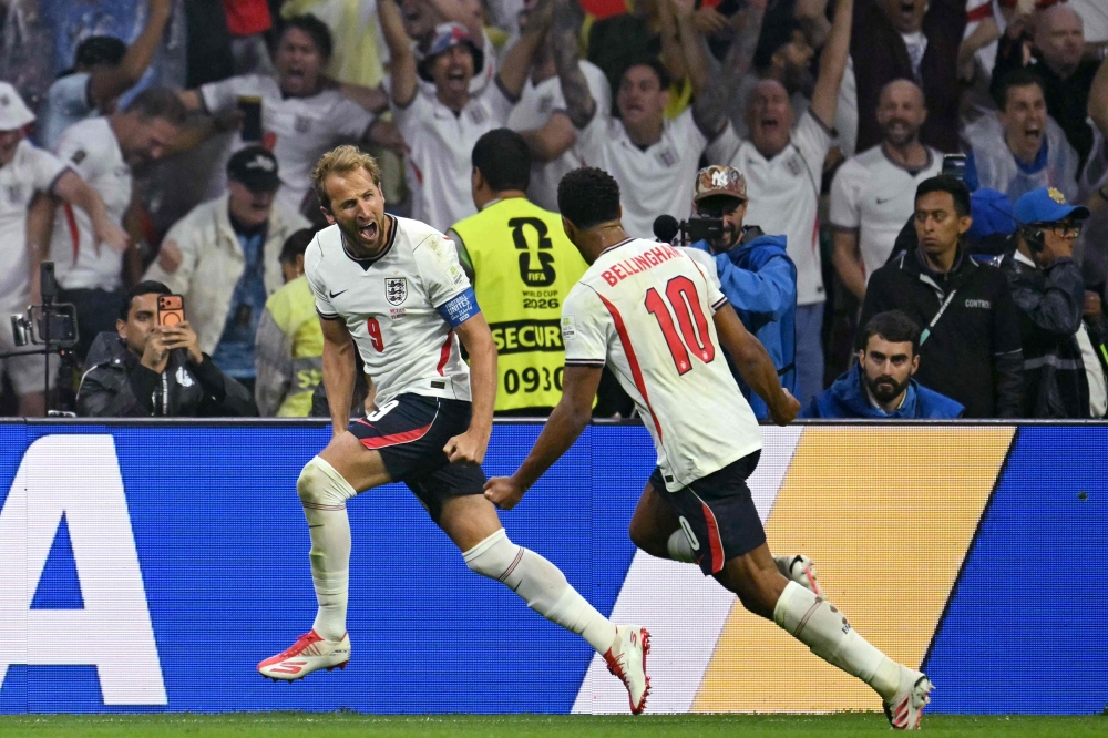 England's forward #09 Harry Kane celebrates scoring his team's third goal with teammate midfielder #10 Jude Bellingham  