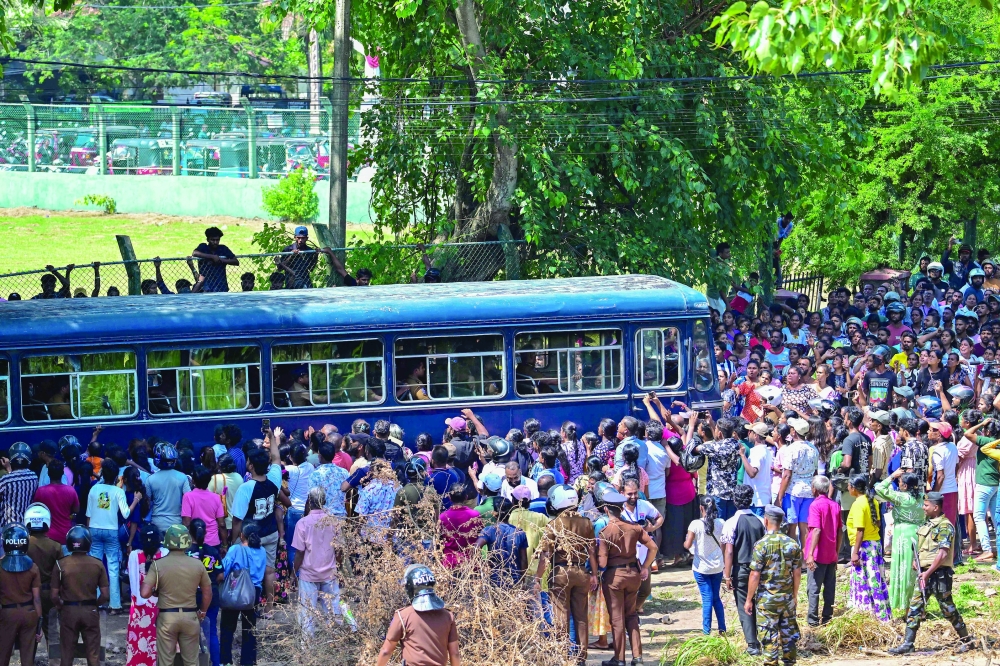 A bus carrying prisoners to be transferred to another jail makes its way following overnight clashes between inmates of two drug gangs at Negombo prison near Colombo on July 6, 2026. Clashes in a Sri Lankan jail have killed 23 people, including four guards, and wounded more than 100 in the country's deadliest prison riot in more than five years, officials said on July 6. (Photo by Ishara S. KODIKARA / AFP)
