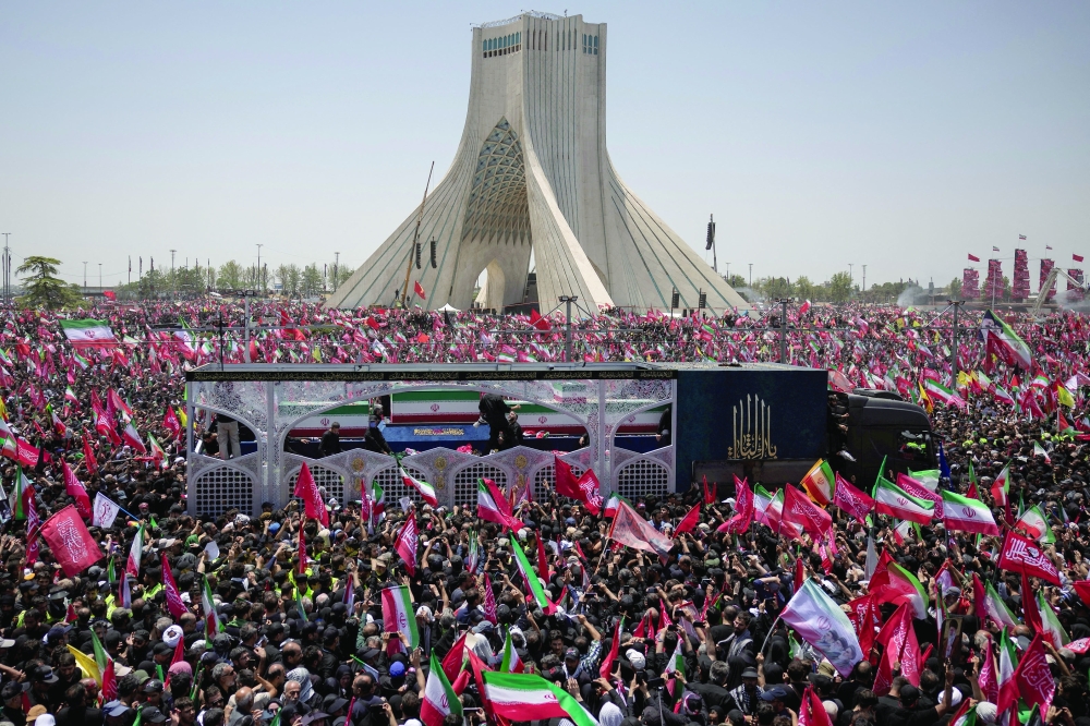 A vehicle carrying the coffins of Iran's late supreme leader Ayatollah Ali Khamenei and members of his family makes its way as people attend a funeral procession in Tehran. — Reuters 