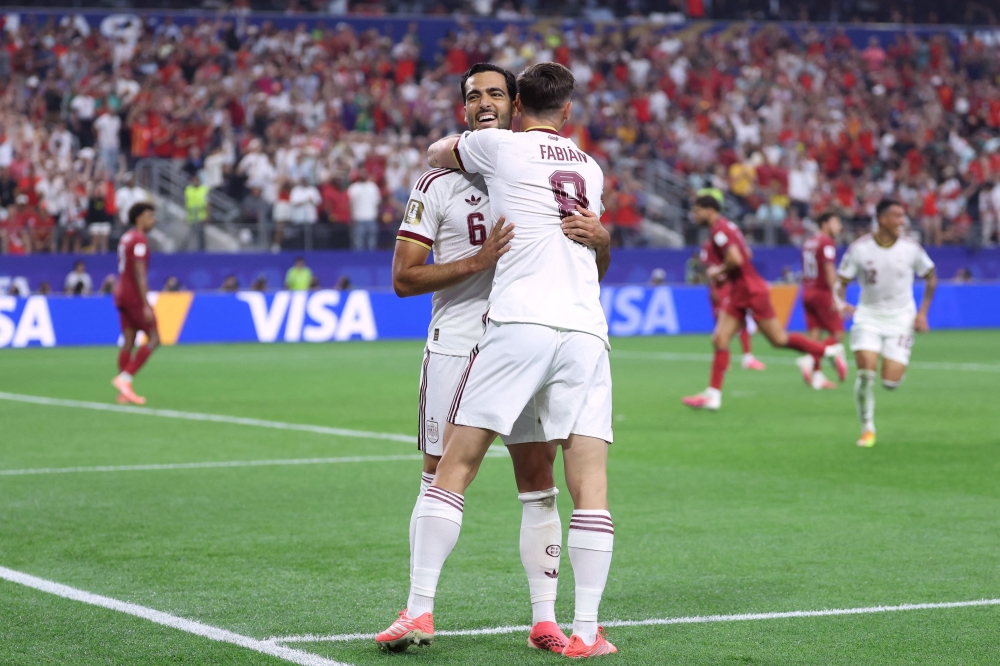 Spain's midfielder #06 Mikel Merino celebrates scoring his team's first goal with teammate midfielder #08 Fabian Ruiz  