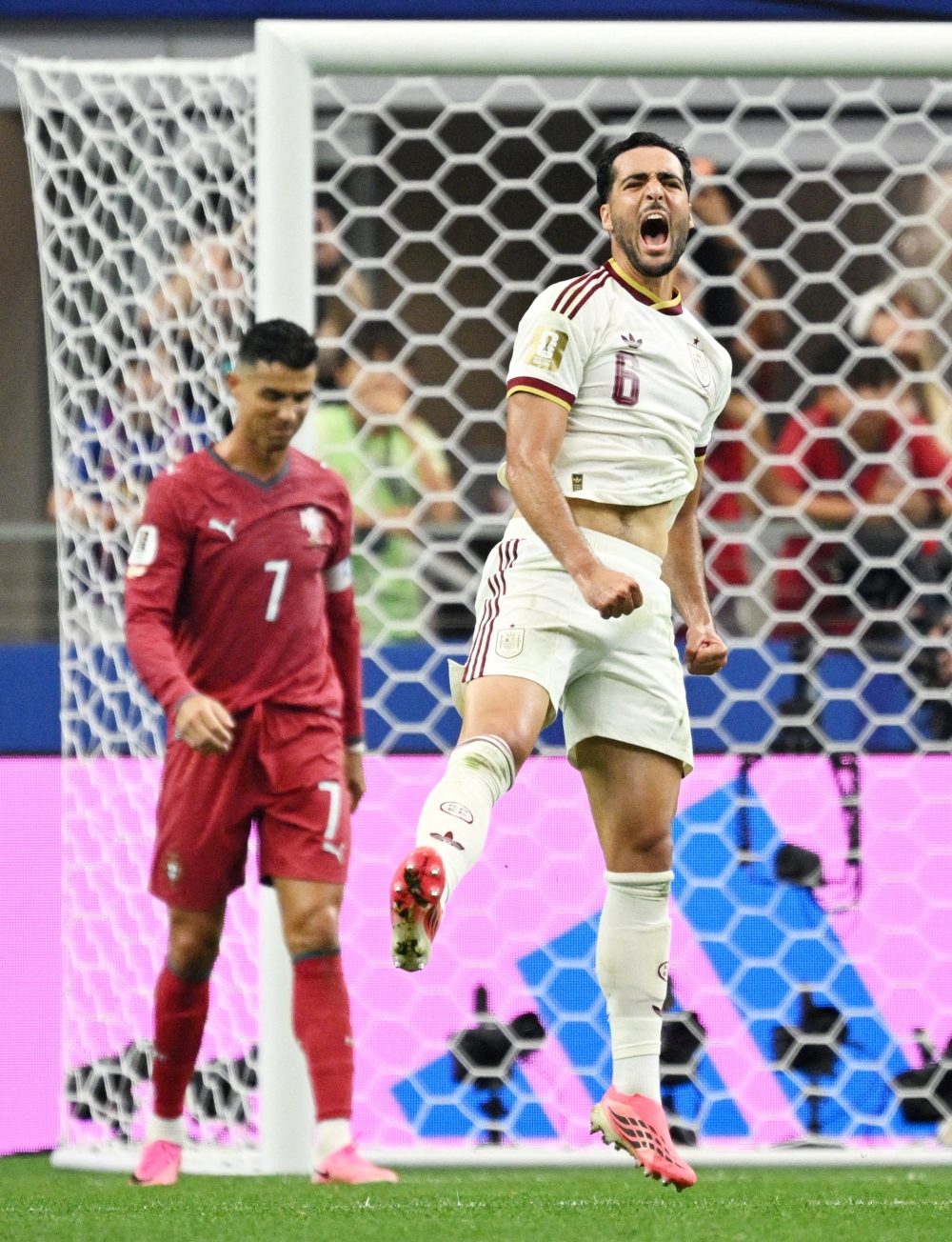  
Spain's Mikel Merino celebrates as Portugal's Cristiano Ronaldo looks dejected after the match as Portugal are eliminated from the World Cup 