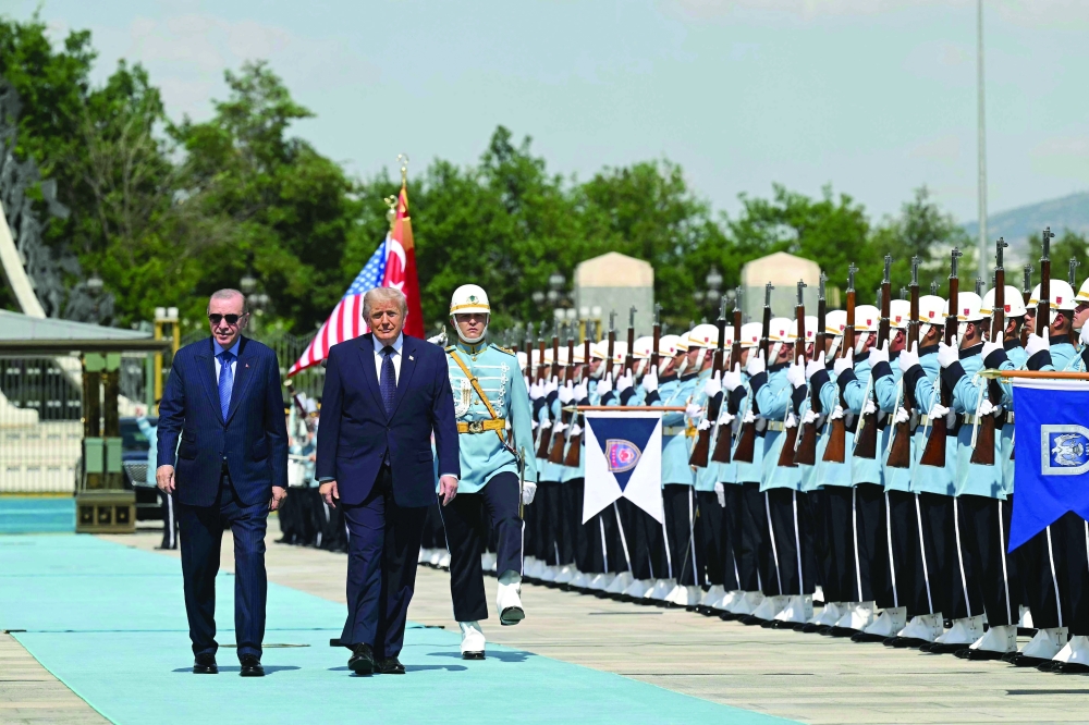 Turkish President Recep Tayyip Erdogan (L) hosts US President Donald Trump for a state arrival ceremony at Bestepe Presidential Compound in Ankara. — AFP