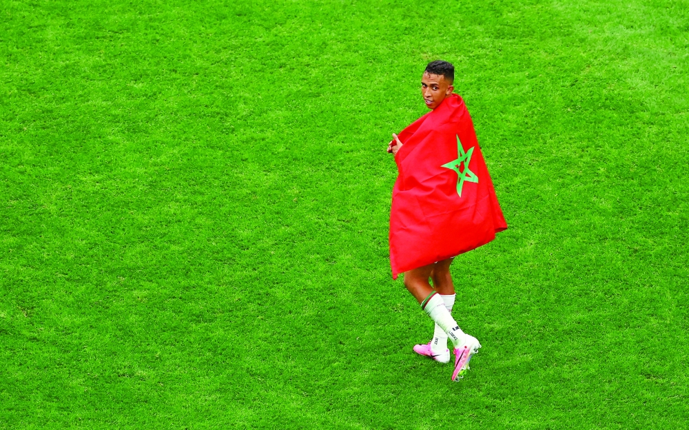 Morocco's Soufiane Rahimi celebrates after the match as Morocco qualify for the quarter final stage of the World Cup. — REUTERS