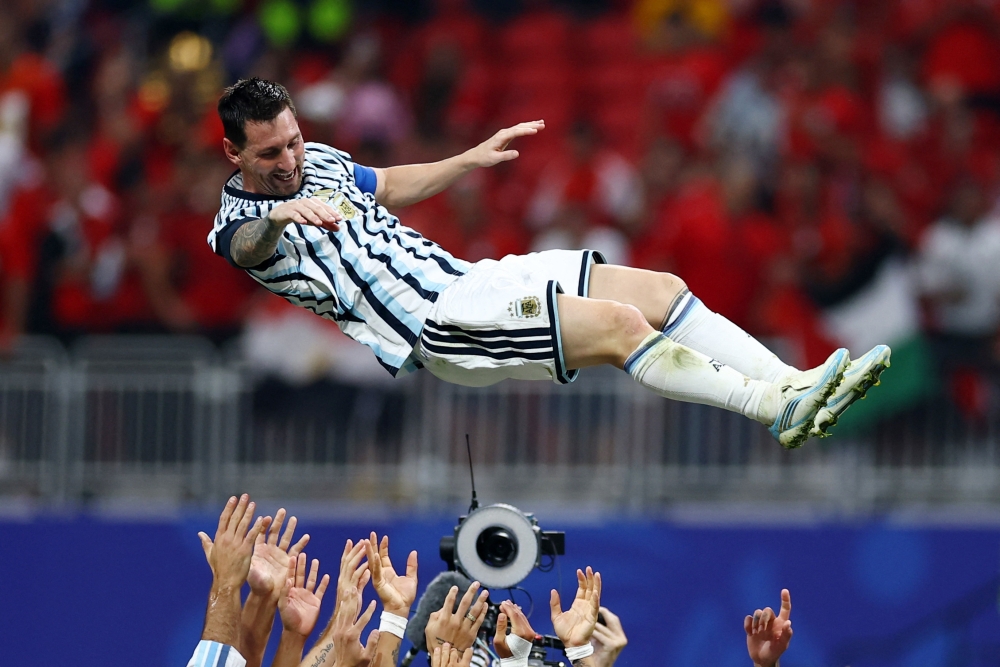  Argentina's Lionel Messi celebrates with teammates after the match 