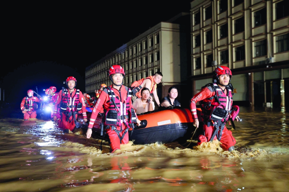 Rescue workers evacuate flood-affected residents in China's southern Guangxi region. — AFP
