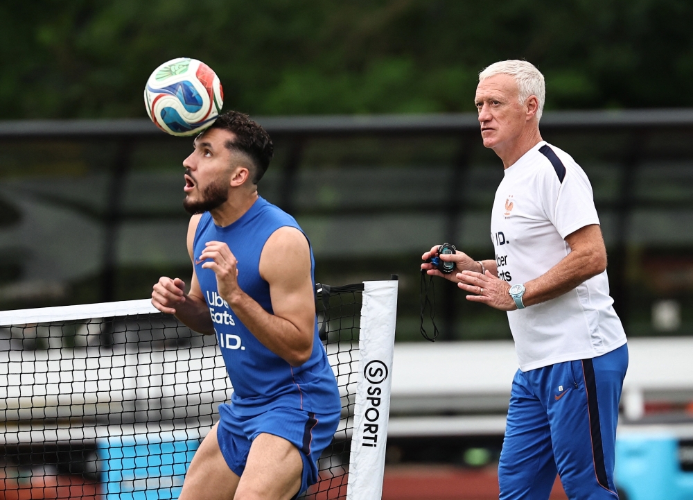  
France coach Deschamps and Cherki during training. — Reuters