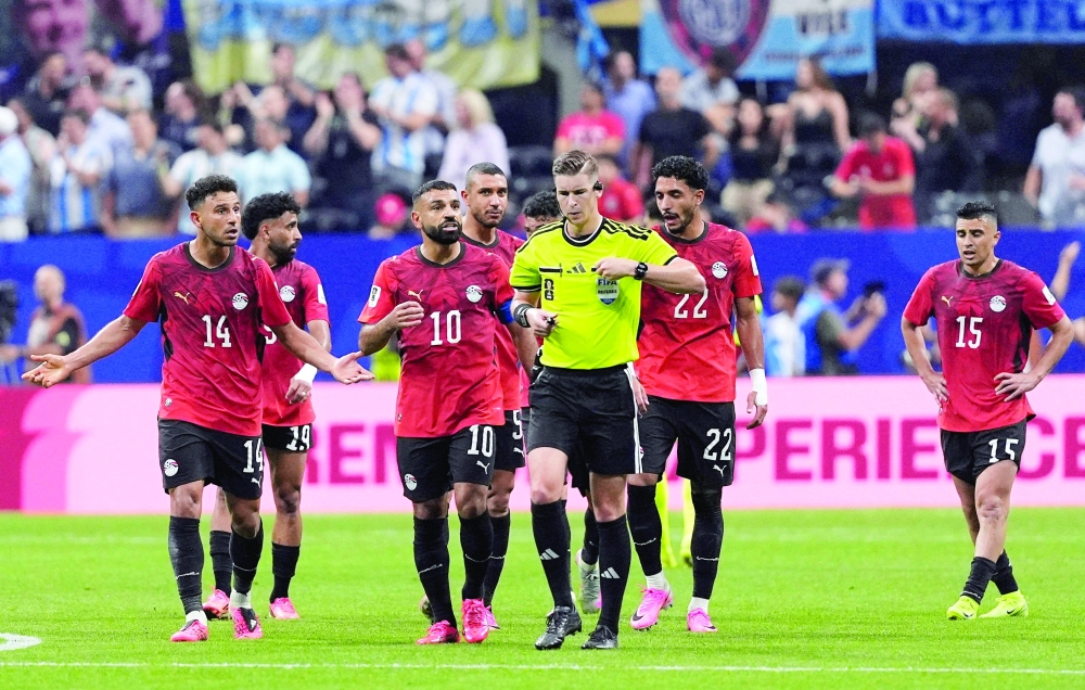 Egypt's Mohamed Salah remonstrates with referee Francois Letexier after Argentina's Enzo Fernandez scores their third goal. — Reuters