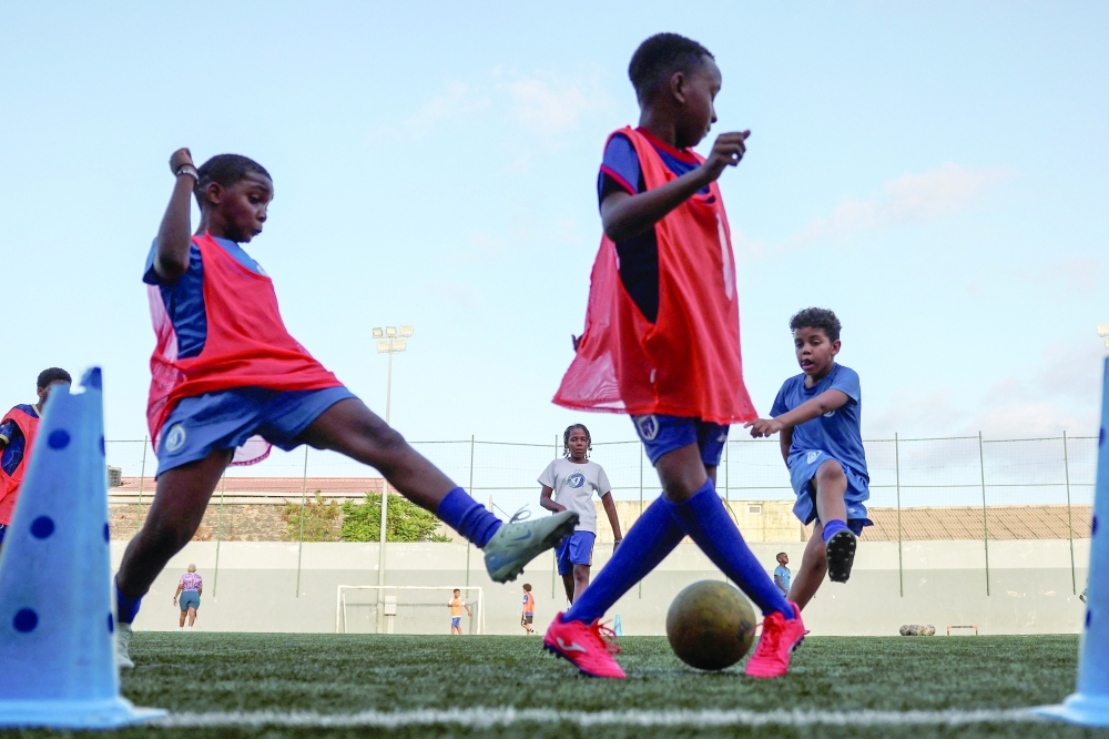 Youth trainees practice during a football training session inside the Bola Pra Frente football academy in Praia, Cape Verde. — Reuters