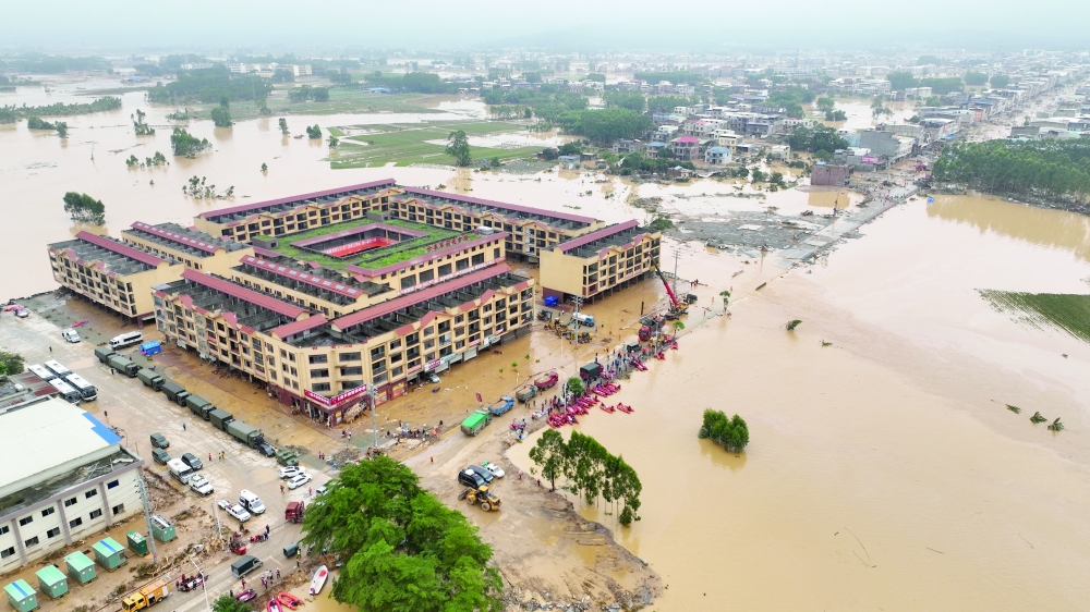 A drone view shows rescue workers conducting relief operations in flood-affected Maling town, after the Liulan reservoir dam breach, following heavy rainfall brought by typhoon Maysak, in Hengzhou, Guangxi Zhuang Autonomous Region, China. — Reuters