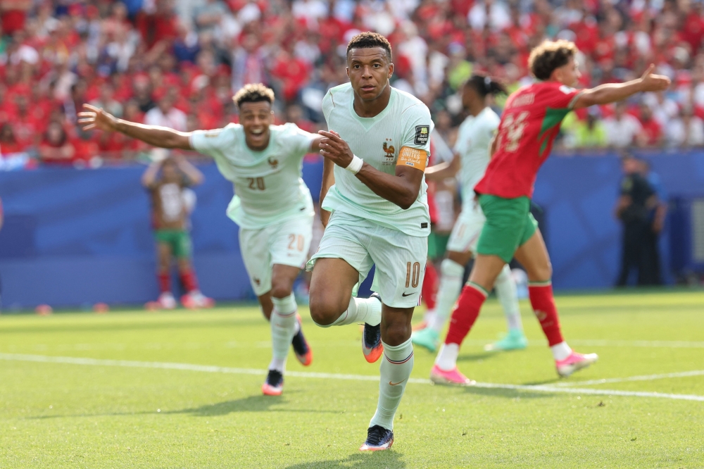 France's forward #10 Kylian Mbappe celebrates scoring his team's first goal  