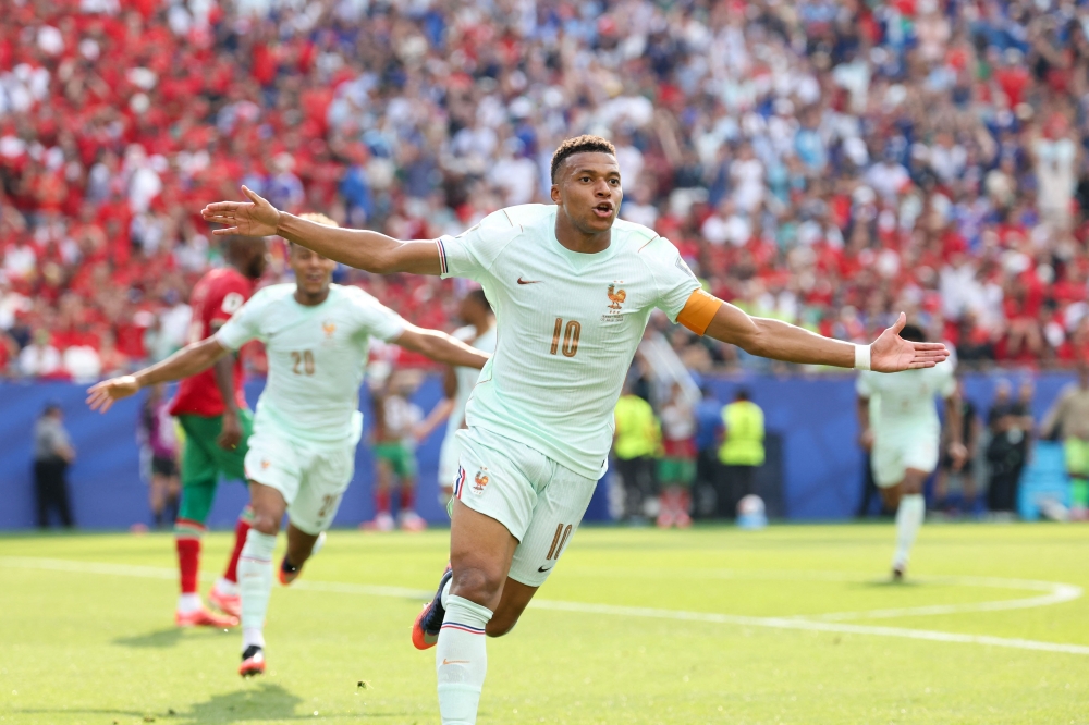 France's forward #10 Kylian Mbappe celebrates scoring his team's first goal  