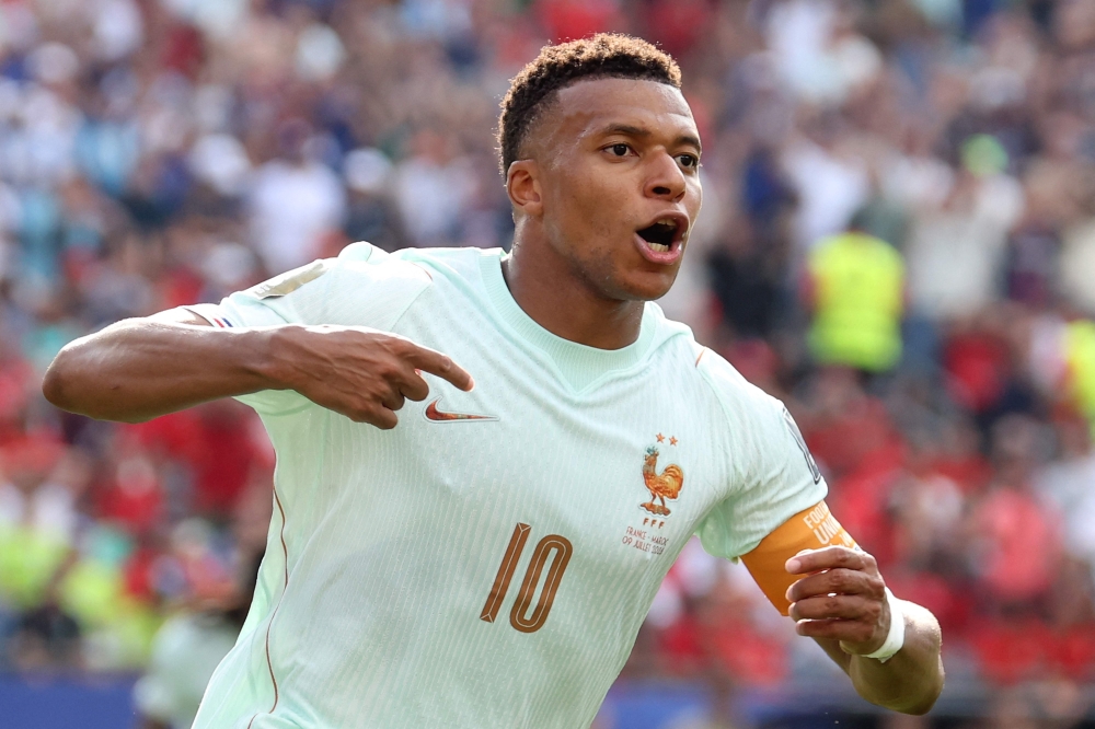 France's forward #10 Kylian Mbappe celebrates scoring his team's first goal  