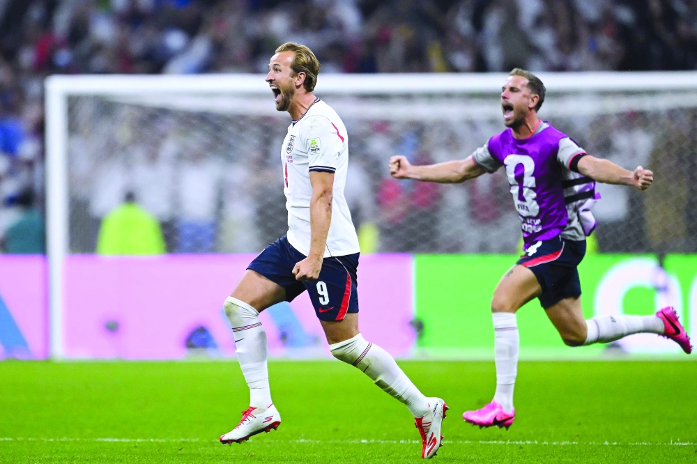 England's forward #09 Harry Kane and England's midfielder #14 Jordan Henderson celebrate after winning the 2026 World Cup round of 16 football match between Mexico and England. — AFP