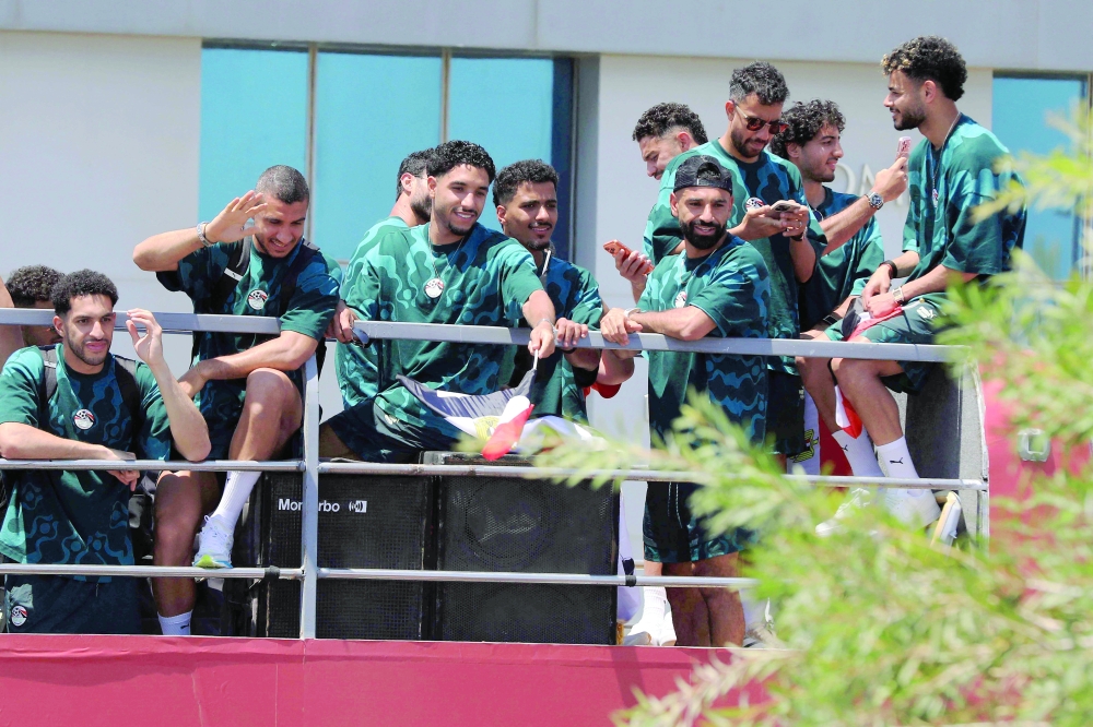 Egypt's players wave from an open-top bus as supporters gathered to welcome them at El-Alamein International Airport in the northern coastal city of El-Alamein. — AFP