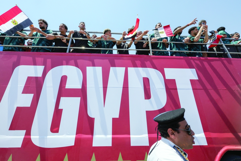 Egypt's national soccer team ride on a bus as they are welcomed by fans at El Alamein International Airport upon their return from the 2026 Fifa World Cup. — Reuters