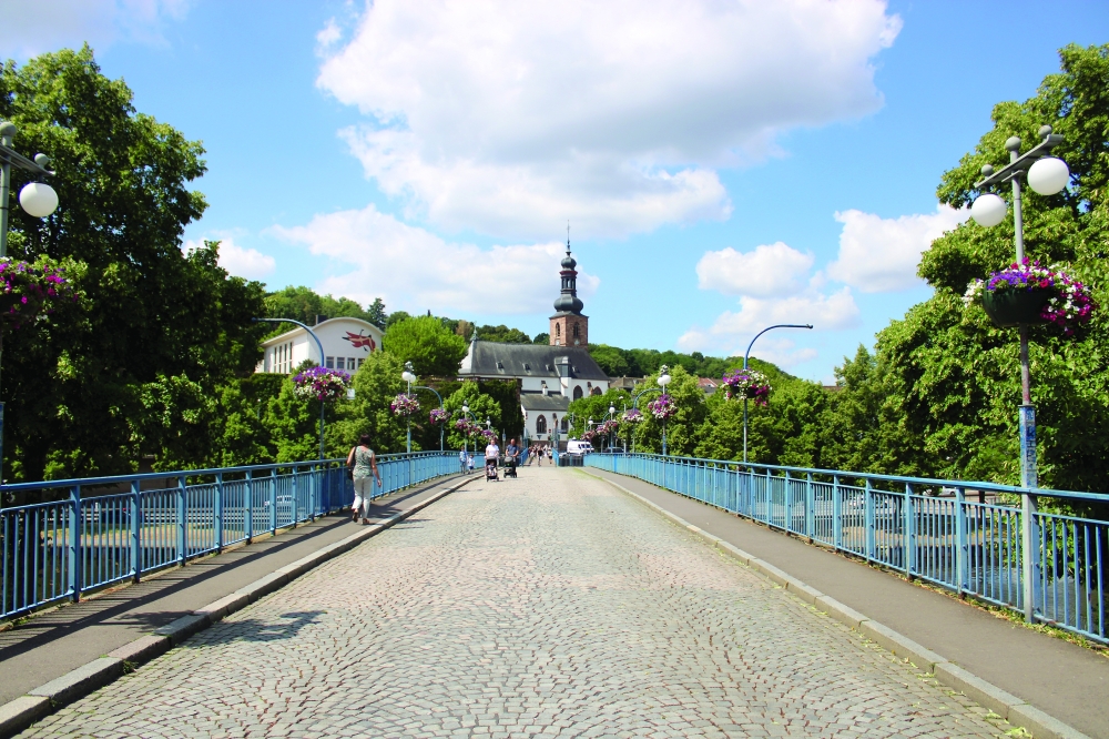 View of Saarbrücken Old Town with the St Johann Basilica overlooking River Saar from the Wilhelm-Heinrich Bridge
