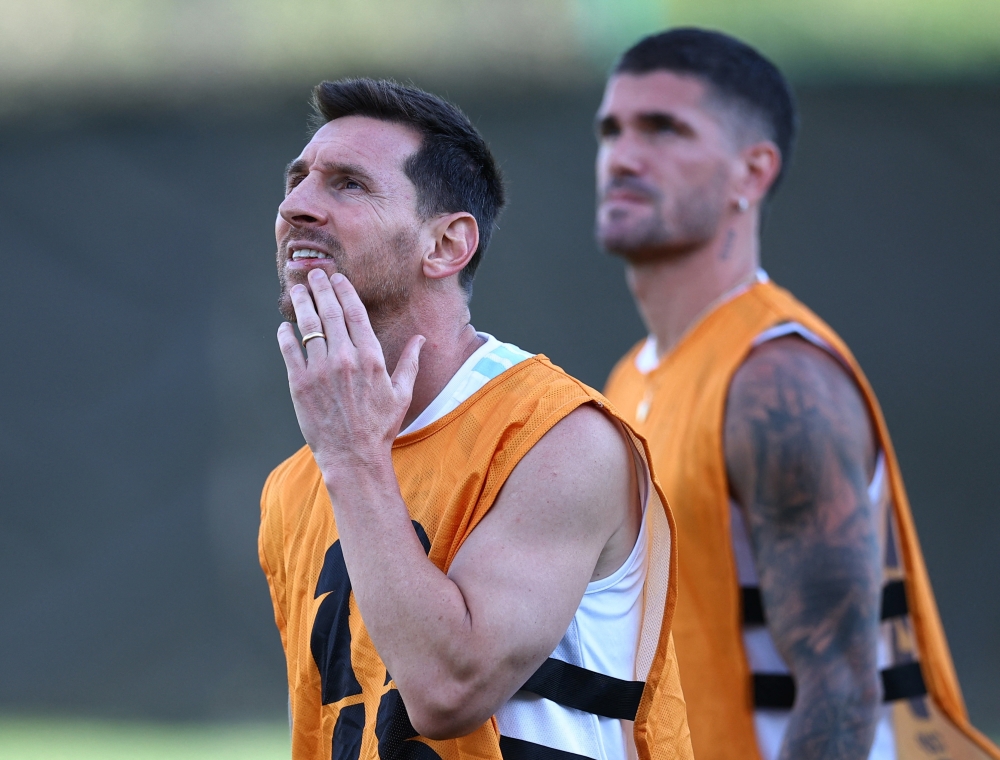  
Argentina's Lionel Messi and Rodrigo De Paul during training  