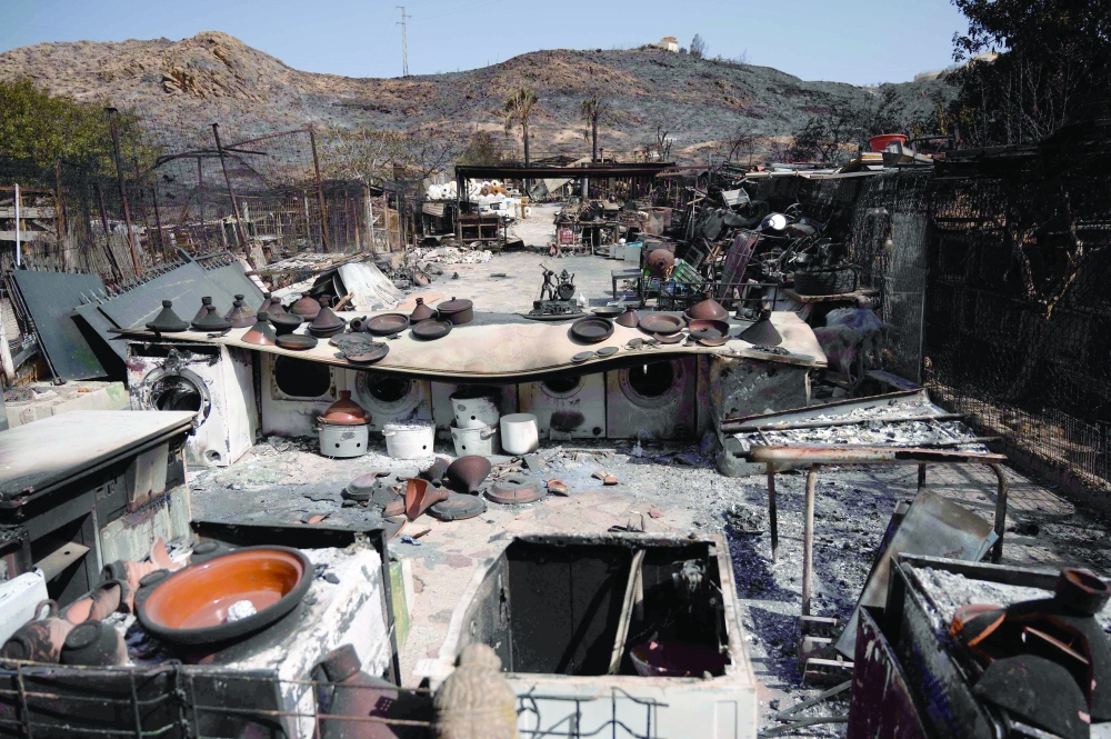 Potteries in the courtyard of a house in a burnt landscape are pictured in Bedar, Almeria Province. — AFP