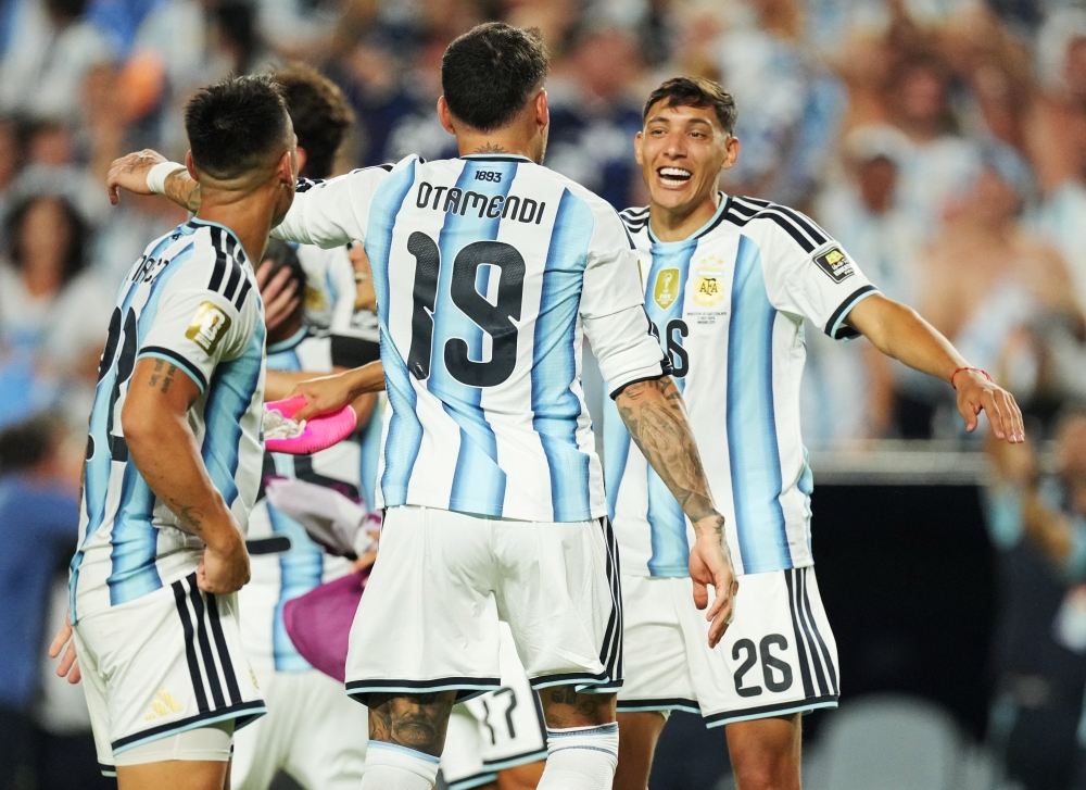  
Argentina's Nicolas Otamendi celebrates after the match with Nahuel Molina 