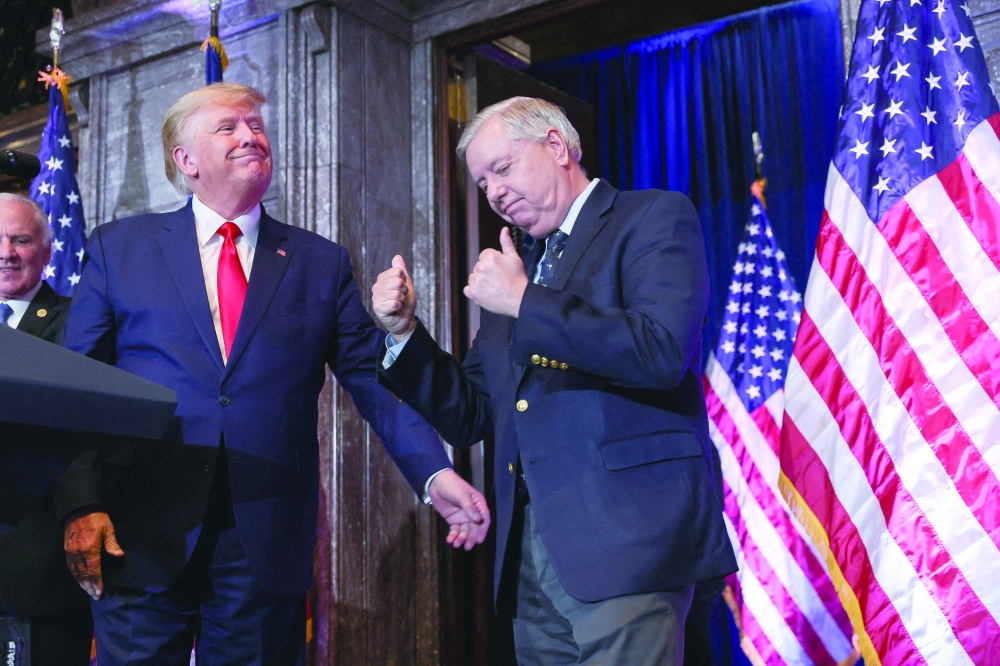 US Senator Lindsey Graham gestures, while standing next to US President Donald Trump at the South Carolina State House in Columbia. — Reuters file photo