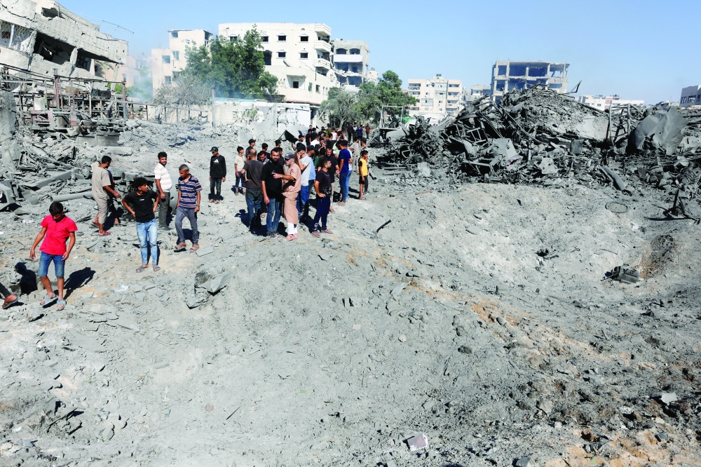 Palestinians inspect the site of an Israeli strike on a metal foundry in Gaza City, July 12, 2026. REUTERS/Dawoud Abu Alkas