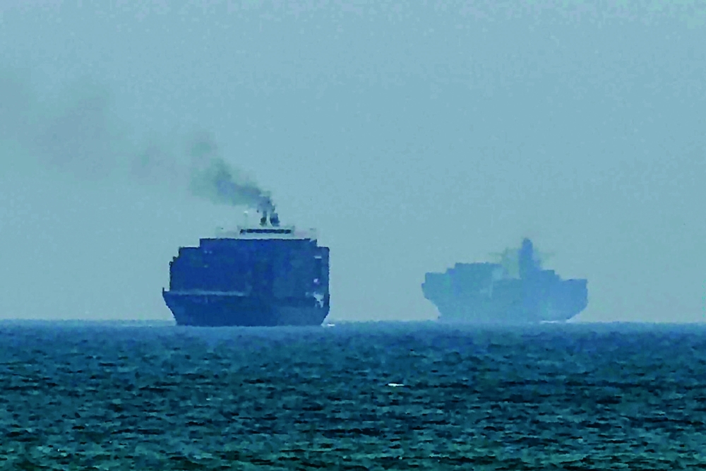 This frame grab shows cargo ships anchoring near the Strait of Hormuz. — AFP