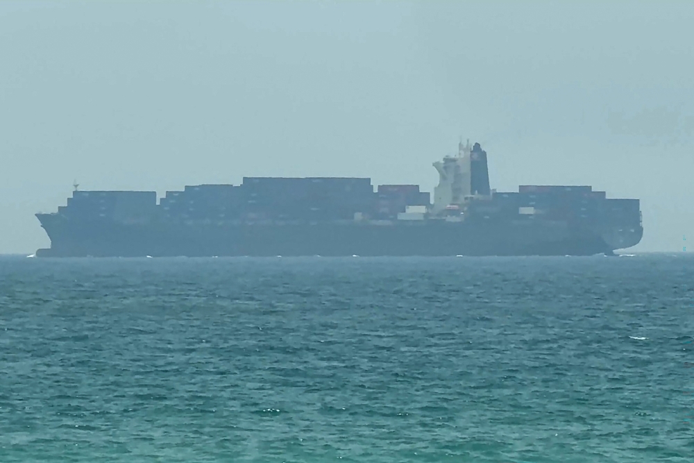 A cargo ship is anchored near the Strait of Hormuz off the eastern coast of the United Arab Emirates at Khor Fakkan.