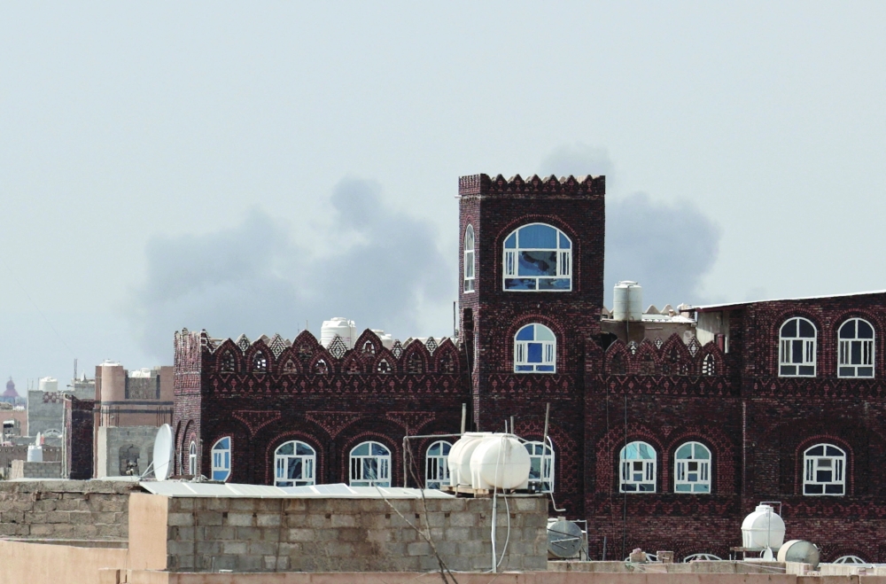 Smoke rises following an air strike at Sanaa International Airport, in Sanaa. — Reuters