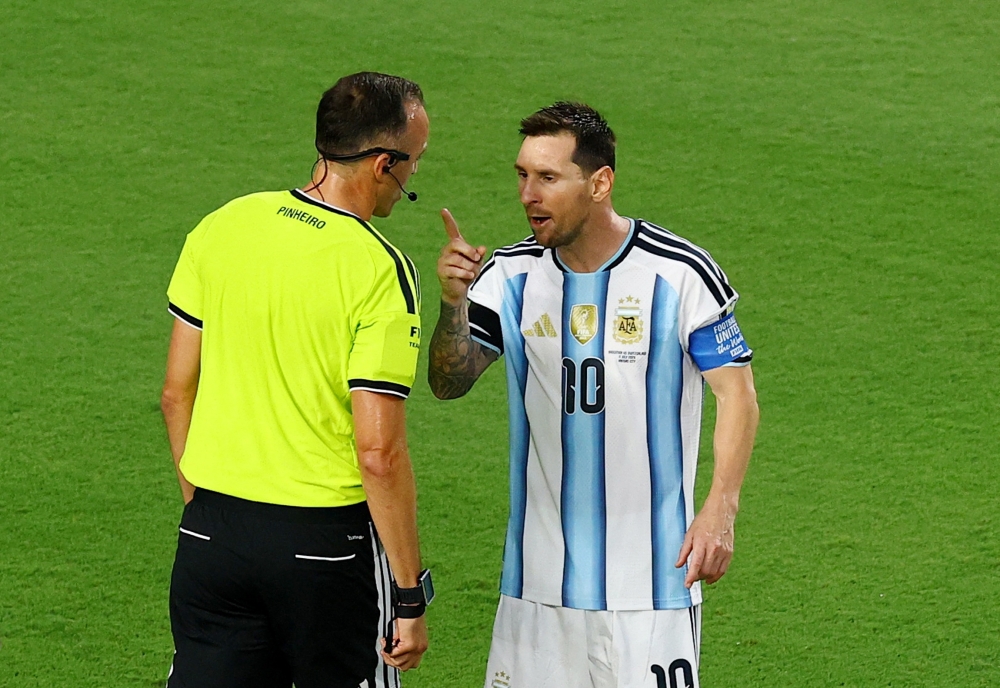  
Argentina's Lionel Messi remonstrates with referee Joao Pinheiro  