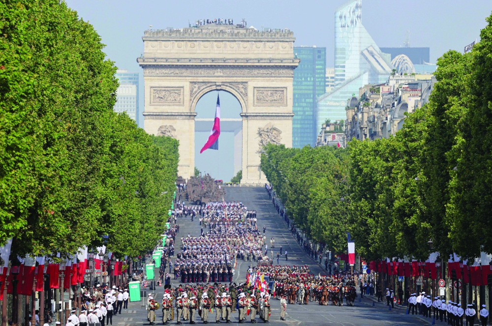 Troops march during the annual Bastille Day military parade on the Champs-Elysees Avenue in Paris. — AFP