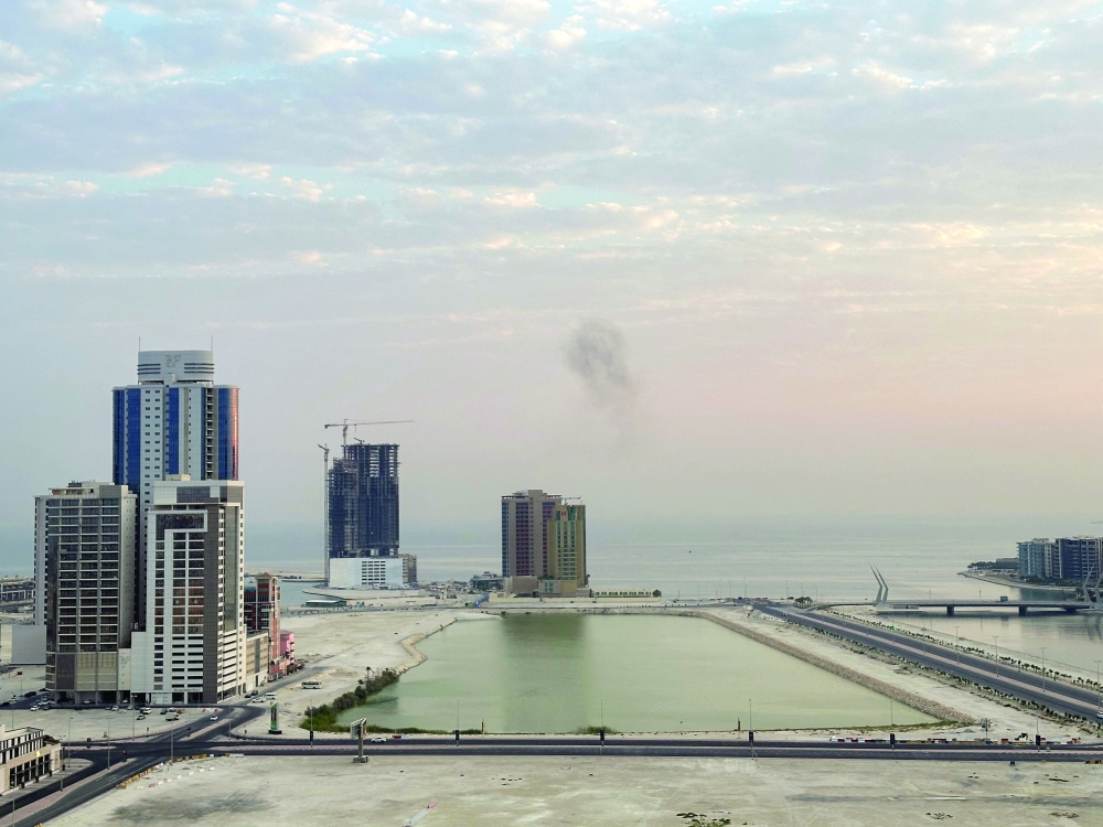 Smoke rises after a drone was intercepted during early morning hours in Manama on Tuesday. — Reuters