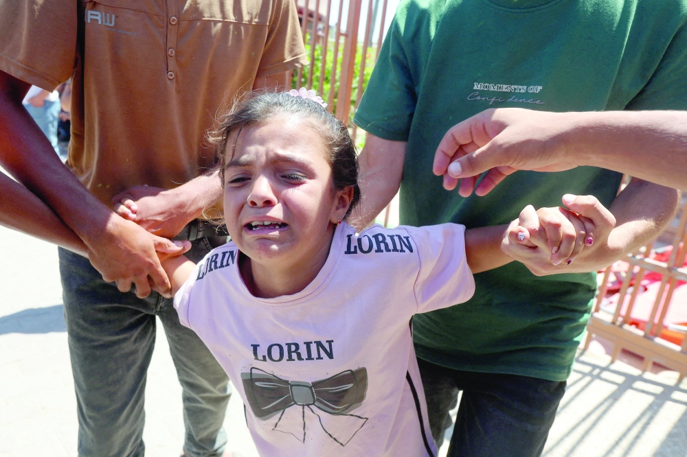 A child reacts during the funeral of Palestinian child Muataz Abu Shaar in Khan Yunis. — Reuters