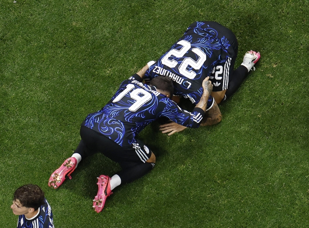  
Argentina's Martinez celebrates second goal with Otamendi. — Reuters  