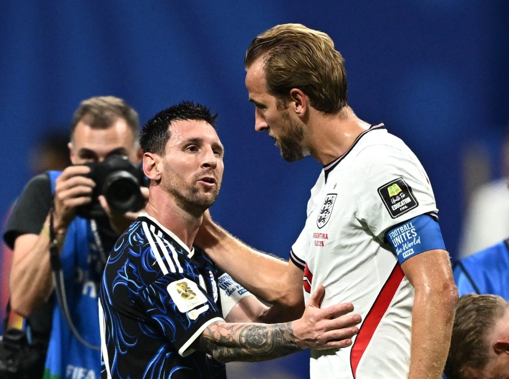  
Argentina's Lionel Messi embraces England's Harry Kane at the end of the match  