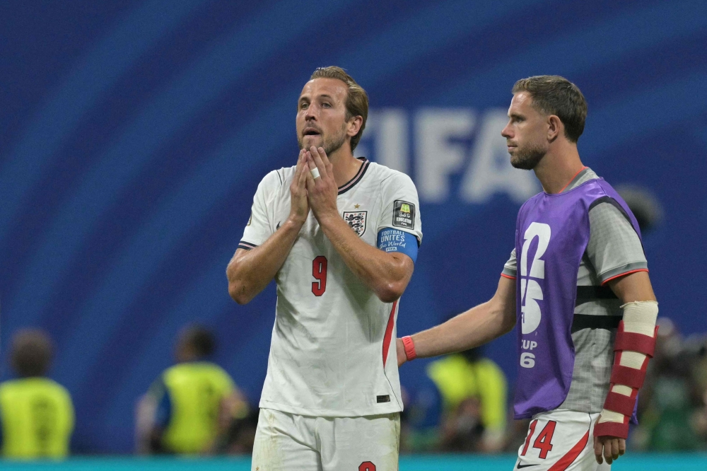England's forward #09 Harry Kane (L) and England's midfielder #14 Jordan Henderson (R) react to their team's defeat  
