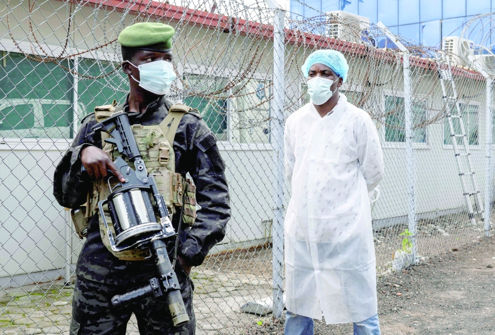 A member of the M23 rebel group stands guard as provincial authorities visit the Rodolphe Merieux Laboratory in Goma, North Kivu province of the Democratic Republic of Congo. — Reuters