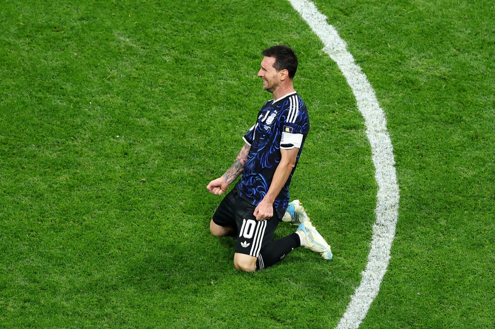  
Argentina's Lionel Messi celebrates after the match as they advance to the World Cup final  