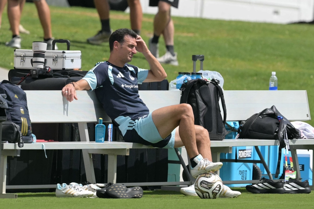 Argentina's head coach Lionel Scaloni (C) sits  
