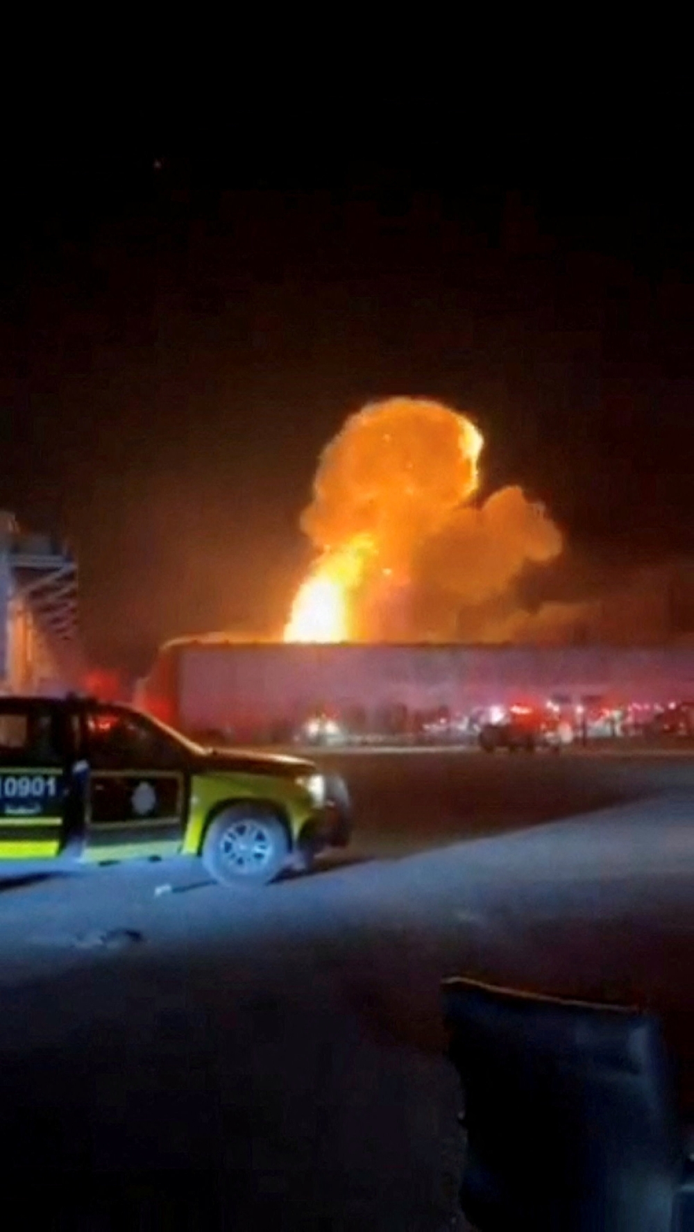 Smoke rises from an explosion following a drone strike on a warehouse in Al Shuaiba, Kuwait, in this still image obtained from social media video released July 14, 2026.  