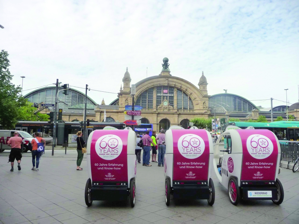 A Velotaxi waits outside Frankfurt Hauptbahnhof at Kaisersack, offering visitors an eco-friendly way