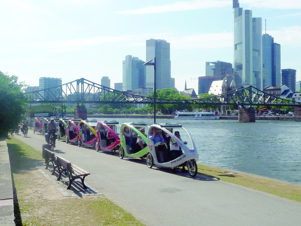 A Velotaxi with Frankfurt’s iconic skyline in the background
