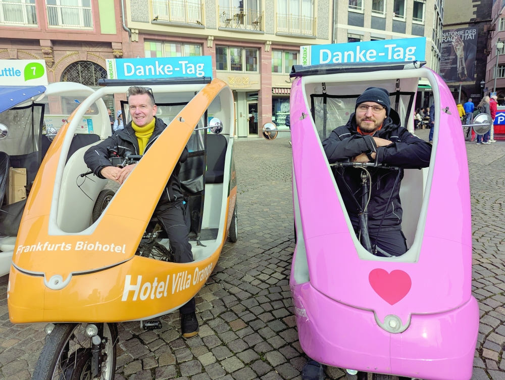 Former Velotaxi owner, Matthias Graf (left), and Christian Kügler, during the official handover of Velotaxi Frankfurt