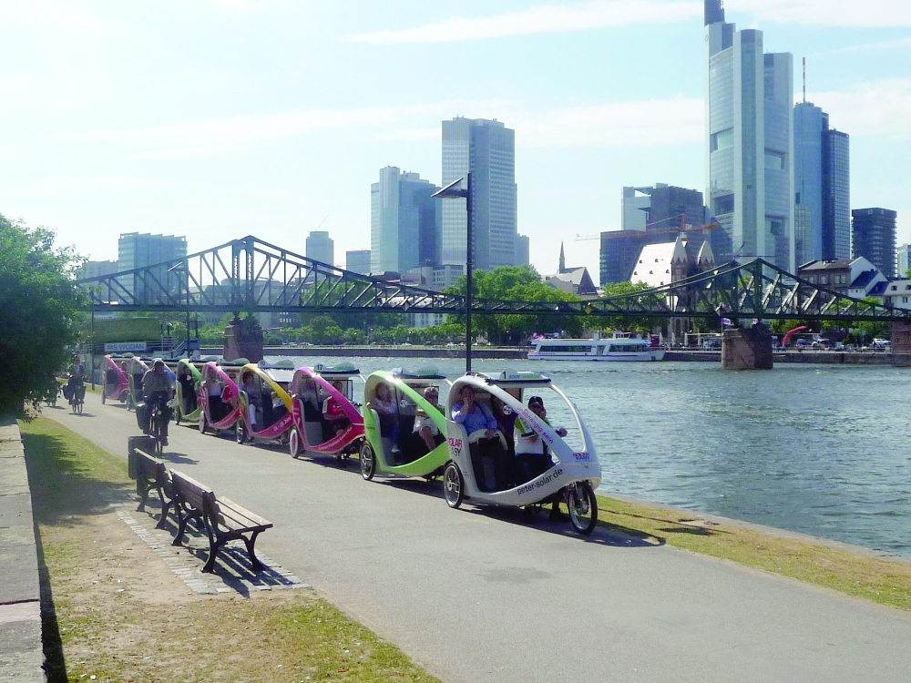 Row of Velotaxis parked along the river