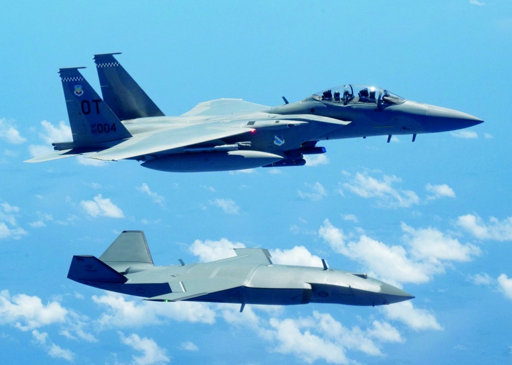 An MQ-28 Ghost Bat and US Air Force F-15EX Eagle II pictured together during Exercise Valiant Shield 2026 over the Philippine Sea