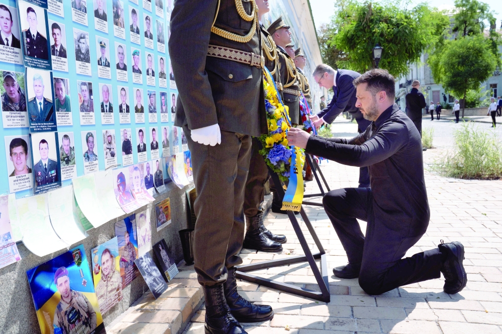 Ukrainian President Volodymyr Zelensky and British Prime Minister Keir Starmer lay a wreath at a memorial wall to those who have fallen during Ukraine's conflicts, in Kyiv