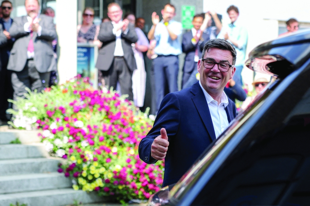 Newly elected leader of Britain's Labour Party Andy Burnham gives a thumbs-up by Gravesend Town Pier as he leaves following his first engagement as leader, in Gravesend, Kent