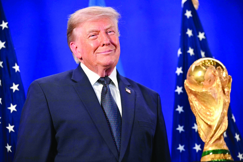 US President Donald Trump stands by the Fifa World Cup Trophy. — AFP